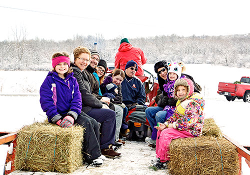 Snowy wagon ride for cut-your-own christmas trees in Hannibal, New York.