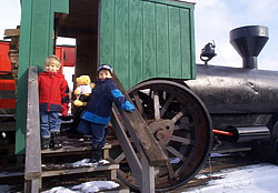 Little engineers make great photo memories at the Christmas Tree Station, a choose and cut Christmas tree farm in Hannibal, NY